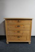 An antique pine four drawer chest