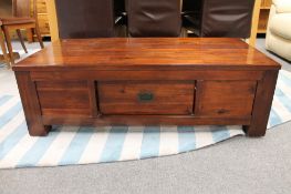A contemporary stained pine coffee table fitted a drawer