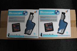 Twenty boxed educational microscopes