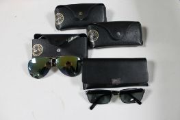 A box of four pairs of Rayban sunglasses and prescription sunglasses together with a pair of Hugo
