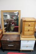 A pine three drawer bedside chest together with two further bedside chests and an oak effect mirror