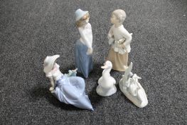 Five Nao figures - boy with scrolls, two female figures,