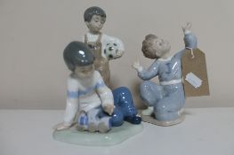 Three Nao figures; boy kneeling,