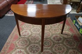 A Victorian mahogany demi-lune table