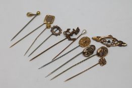 A collection of gold and other pins CONDITION REPORT: One pin stamped 'Gold',