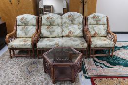 A bamboo and wicker conservatory suite together with a hexagonal two tier coffee table