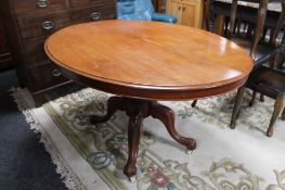 A Victorian oval tilt top breakfast table on four way pedestal
