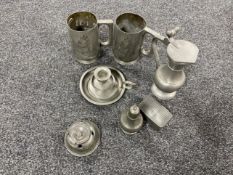 A basket of antique pewter ware - candlestick, snuff box, salt seller,