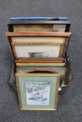 A luggage case containing framed pictures and prints