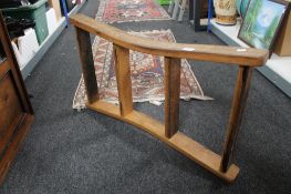 A wooden wall shelf constructed of whisky barrel staves