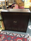 A reproduction mahogany double door cabinet