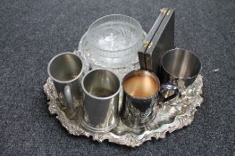 A silver plated tray, pewter tankards,