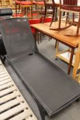 A metal framed lounger chair