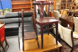 A small cafe chair together with a two tier stand