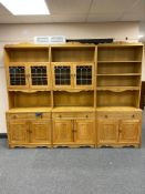 A three piece blonde oak bookcase