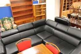 A black leather corner lounge suite