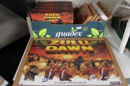 A box of five framed Zulu Dawn prints and six Zulu Dawn VHS box sets