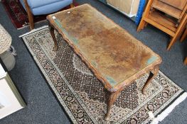 A walnut glass topped coffee table
