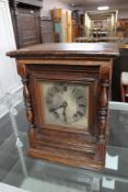 A continental oak cased bracket clock with silvered dial