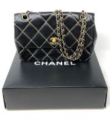 A lady's Chanel black stitched leather chain shoulder bag,