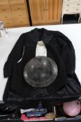 An early 20th century warden helmet together with a vintage waistcoat and tail coat