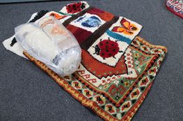 A quantity of wool hangings and floor coverings