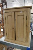 A pine double door cabinet CONDITION REPORT: This is a wall cabinet.