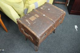 A vintage trunk on metal stand