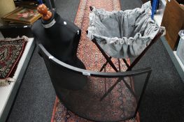 A folding sewing stand together with a mannequin and a fire screen