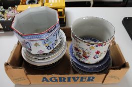 A box of decorative china plates,