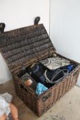 A wicker basket containing a collection of lady's handbags