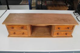 A four drawer wooden desk stand