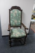 A carved oak armchair with studded tapestry seat
