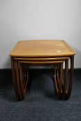 A nest of three teak tables