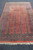A Tekke design rug on red ground,