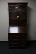 A reproduction mahogany bureau bookcase