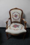 An antique style carved walnut armchair in tapestry fabric