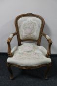An antique style carved walnut armchair in tapestry fabric