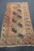An Afghan Bokhara rug on brown ground,