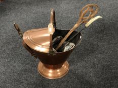 A Victorian copper swing handled coal scuttle with shovel, carpet beater,