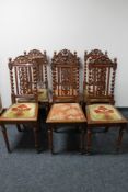A set of seven carved oak dining chairs