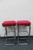 A pair of tubular metal bar stools