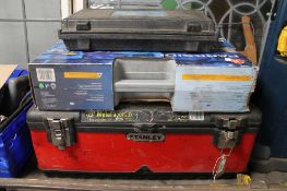 A tool box containing tools, laser level etc.