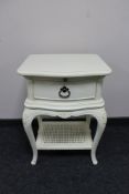 A cream painted single drawer bedside table