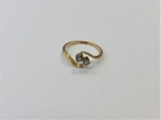A two stone diamond crossover ring, size N1/2.