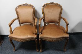 A pair of carved walnut armchairs