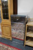 A mirrored bedside cabinet