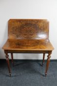 A nineteenth century walnut tea table CONDITION REPORT: Split to veneer on top.