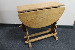 A light oak drop leaf table