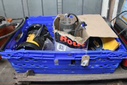 A crate of bench grinder, router,